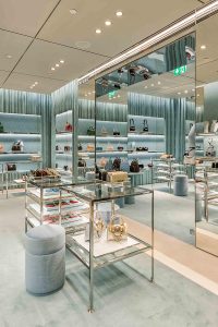 Miu Miu store interior, Jeddah, Saudi Arabia by architect and interior designer Roberto Baciocchi using Double Stone Steel PD colored stainless steel Champagne Mirror for fixtures and furniture detailing