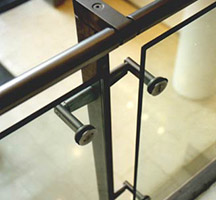 Forged and machined stainless steel uprights and handrail with toughened glass balustrade panels Forged and machined stainless steel uprights and handrail with toughened glass balustrade panels