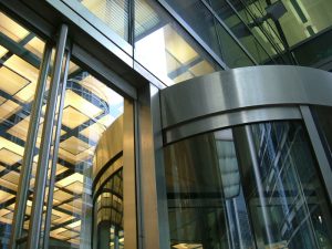 Glazed, stainless steel revolving doors to office development in Canary Wharf, London, UK
