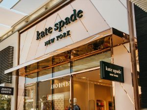 Kate Spade retail store, San Diego, California. - Canopy, window glazing bars and façade inset diagonal detailing in Double Stone Steel PVD colored stainless steel Rose Gold Mirror.