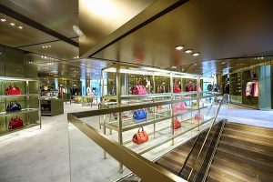 Interior of Miu Miu flagship store in Beijing. Panels and ceiling finished in Double Stone Steel PVD coated coloured stainless steel champagne SS04 4 brushed. - Architect Roberto Bachiocci