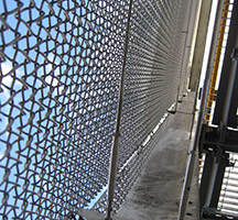 Chain link curtain wall running 100m length in Wood Lane tube station, London. Chain link curtain wall running 100m length in Wood Lane tube station, London.