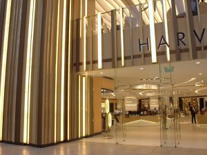 Harvey Nichols retail department store, The Avenues, Kuwait. - Undulating façade, columns and detailing in Double Stone Steel PVD colored stainless steel Royal Gold Mirror.