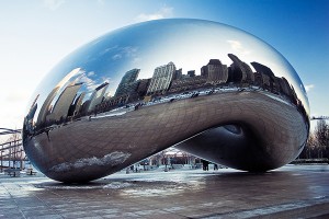 The sculpture Cloud Gate by Anish Kapoor showing the reflected skyline of Chicago in its apparently seamless polished stainless steel surface.