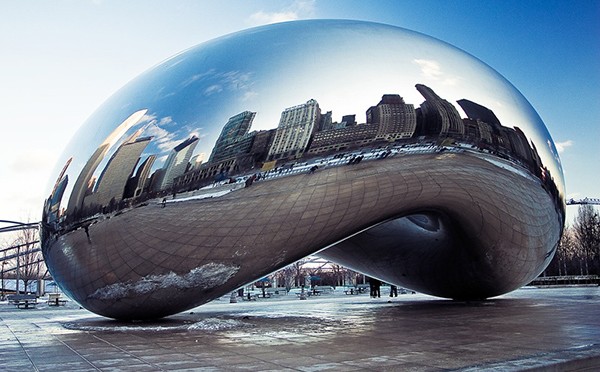 The sculpture Cloud Gate by Anish Kapoor showing the reflected skyline of Chicago in its apparently seamless polished stainless steel surface.