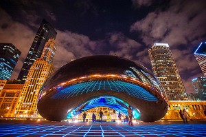 The reflections in the mirrored stainless steel surface of the Cloud Gate sculpture, Chicago by Anish Kapoor, dramatically illuminated at night.