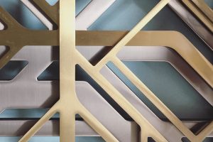 Three-layered laser-cut screens used as decorative wall façade in Double Stone Steel PVD colored stainless steel Champagne Brush, Brass Brush and powder-coated stainless steel in bronze. - Axtell House, London UK. - Architects: Darling Associates