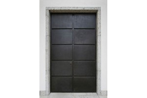 Classically influenced double door in bronze and stone by German architects. Architekt Carsten Vogel