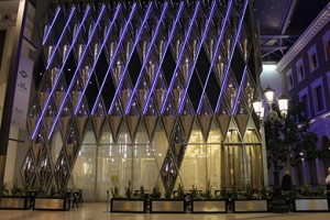 Façade of the Roberto Cavalli Caffé, The Avenues, Kuwait. Fabricated by Double Stone Steel from 2mm 316 grade stainless steel. Showing the façade Illuminated with purple LED lighting.