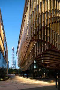 PVD stainless steel in Rose Gold Vibration glows in an evening shot of the Shanghai Bund Arts and Cultural Centre. - Architects: Foster & Partners; Heatherwick Studio - PVD: Double Stone Steel in partnership with John Desmond Ltd