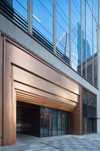 PVD stainless steel in Rose Gold Vibration reflects the light with this stepped door entry at the Shanghai Bund Financial Centre. - Architects: Foster & Partners; Heatherwick Studio - PVD: Double Stone Steel in partnership with John Desmond Ltd