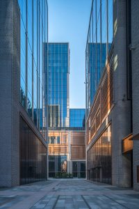 A dramatic avenue between the buildings at the Shanghai Bund Financial Centre showing PVD stainless steel in Rose Gold Vibration used for door reveals and window surrounds. - Architects: Foster & Partners; Heatherwick Studio - PVD: Double Stone Steel in partnership with John Desmond Ltd