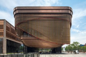 The façade of the Shanghai Bund Arts and Cultural Centre with a view towards Pudong. Fabricated from PVD stainless steel in Rose Gold Vibration. - Architects: Foster & Partners; Heatherwick Studio - PVD: Double Stone Steel in partnership with John Desmond Ltd