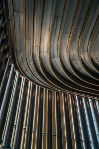 A view of the moving veil of tubes looking up at the undulating ceiling detail at the Shanghai Bund Arts and Cultural Centre. Fabricated from PVD stainless steel in Rose Gold Vibration. - Architects: Foster & Partners; Heatherwick Studio - PVD: Double Stone Steel in partnership with John Desmond Ltd