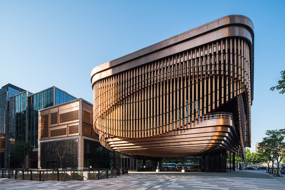 Double Stone Steel PVD stainless steel in Rose Gold for façades and tubular drops: John Desmond Ltd. The Arts and Cultural Centre, Shanghai Bund Financial Centre, China. - Architects: Foster & Partners; Heatherwick Studio