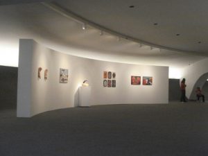 Sweeping curved white walls display artwork in Oscar Niemeyer’s Museu de Arte Contemporânea de Niterói, Brazil. Photography by Lola Adeokun