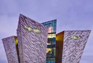 Titanic Belfast Maritime Museum, Belfast: By architectural practices CivicArts and Todd Architects with interior designer Kay Elliott. The cladding of the 4 ‘pointed hulls’ of the façade of this 2012 signature project comprises 3,000 faceted silver anodised aluminium plates.