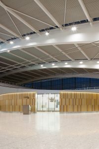 Custom-designed screen to 1st Class area, T5 Terminal, Heathrow airport, London. Comprising fluted sections in Double Stone Steel PVD Colored Stainless Steel Champagne, Chocolate and Almond Gold Brush.