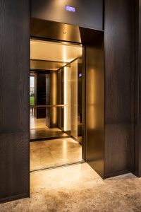 Fenman House, Kings Cross, London mixed use property development elevator interior in Double Stone Steel PVD colored stainless steel Bronze Brush.