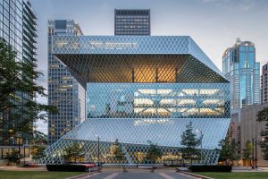 Seattle Central Library. Architects: OMA (Rem Koolhaas + Joshua Prince Ramus) and LMN Architects. Front elevation of the building where the cross bracing steel structure is seen behind the glass facade. The complex geometry responds to the local conditions such as views, orientation and urban density. Image by Hoffman Construction Company.