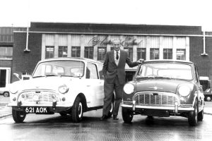 Sir Alec Issigonis at Austin, Longbridge with one of the first Minis (621 AOK) and a 1965 Morris Mini Minor Deluxe.