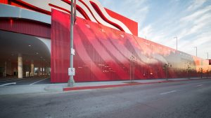 The custom perforated metal screen at the back of the building mimics the stainless ribbons to provide cohesiveness and tie in the Petersen Museum’s Parking Garage with the larger facade. Photography by Tex Jernigan