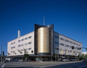 The former May Company building was a department store designed and built in 1939 by architects A. C. Martin and Samuel Marx. Its eye-catching southwest corner hemi-cylinder, clad in Italian gold-glass mosaic, was designed to attract suburban motorists. Photography by Carol Highsmith